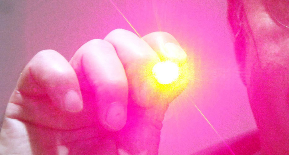 Eine Hand mit einem Laserpointer (Foto: © dpa)