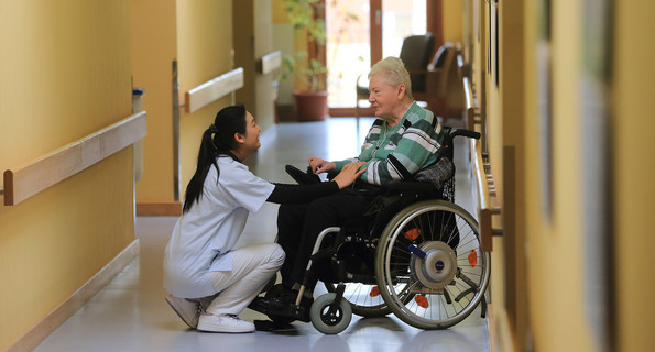 Symbolbild: Eine Pflegeassistentin mit einer Bewohnerin des Seniorenzentrums der Arbeiterwohlfahrt (AWO).