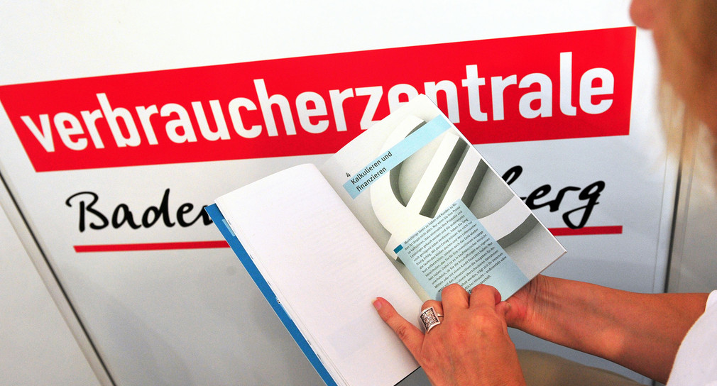 Eine Frau liest in der Verbraucherzentrale Baden-Württemberg in Stuttgart ein Buch (Bild: © dpa).