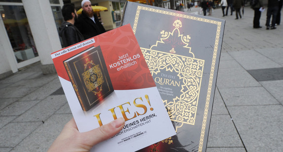 Ein von Salafisten verteilter Koran wird in der Hand gehalten. (Foto: dpa)