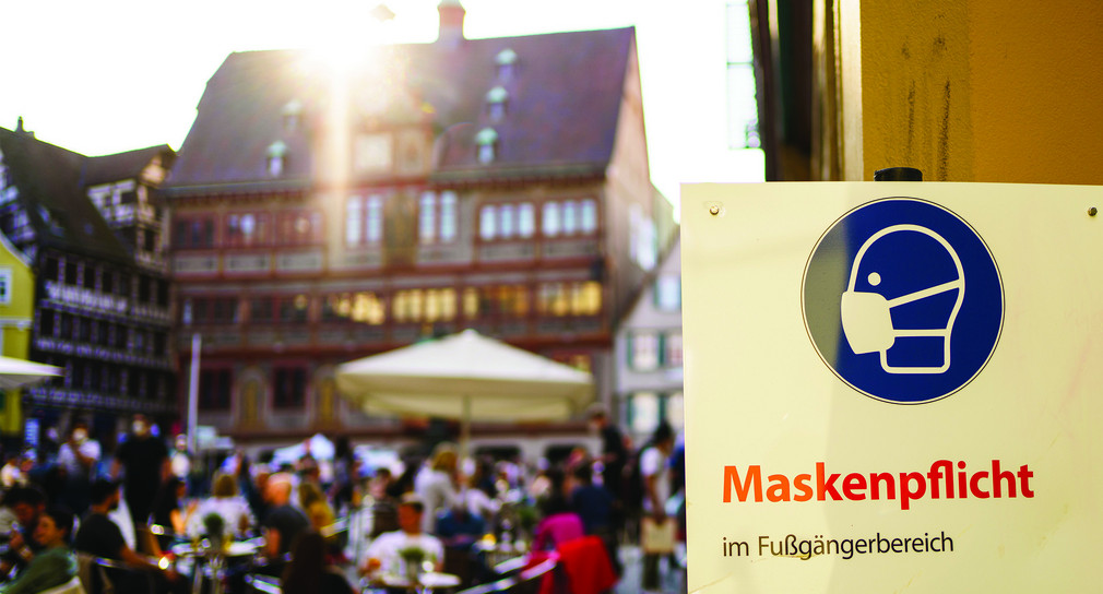 Ein Schlid zur Maskenpflicht hängt in einer Fußgängerzone in Tübingen.