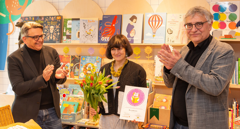 Kunststaatssekretär Arne Braun (rechts) bei der Verleihung des Gütesiegels in der Stuttgarter Kinderbuchhandlung BUCHSTÄBCHEN