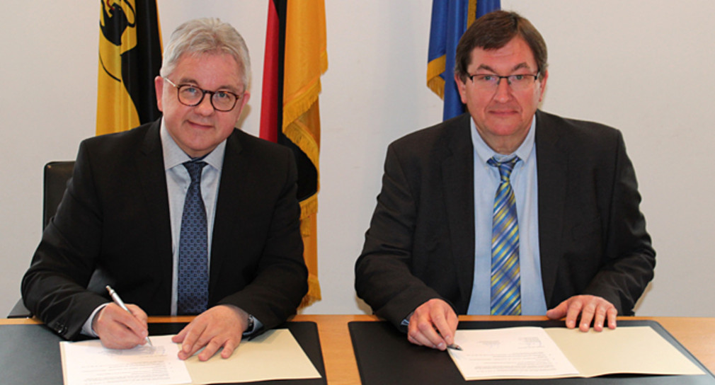 Der Minister der Justiz und für Europa, Guido Wolf (l.) und der Verbandsdirektor des Volkshochschulverbands Baden-Württemberg, Dr. Hermann Huba (r.) bei der Unterzeichnung einer Kooperationsvereinbarung über Rechtskundeseminare für Flüchtlinge und Asylbewerber (Foto: Justizministerium Baden-Württemberg)