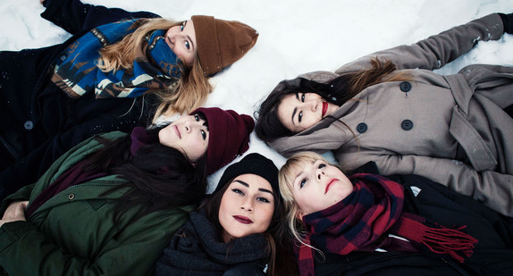 Mädchen liegen im Schnee