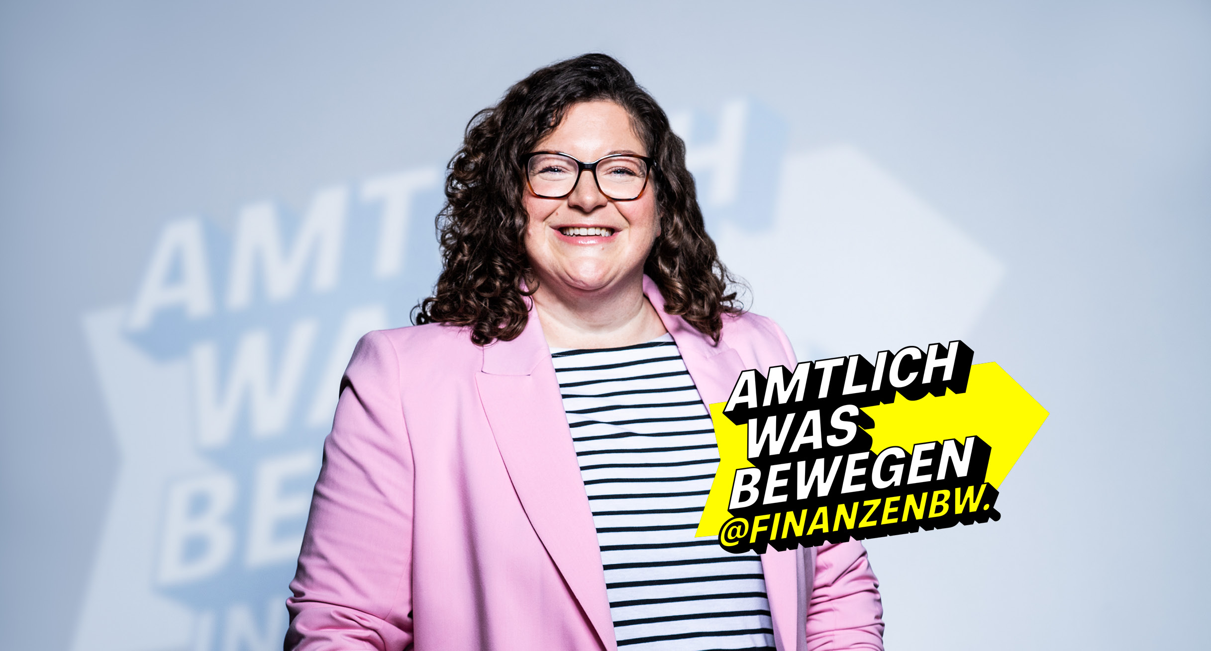 Frau im pinken Blazer lächelt, stellvertretend für das Team hinter @FinanzenBW.